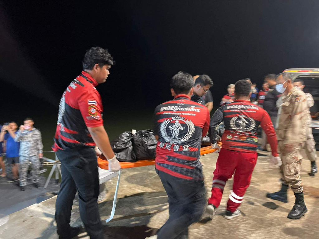 In this image released by Romsai Rescue Foundation Satun, Thai Navy carry a body which is believed to be one of passengers from a boat that believed sank near Tarutao island, Satun, southern Thailand, Sunday, Nov. 9, 2025. (Romsai Rescue Foundation Satun via AP)
