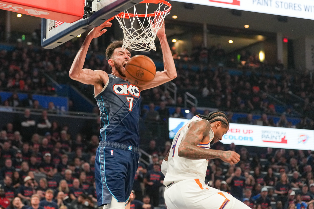 Oklahoma City Thunder center Chet Holmgren, left, dunks over Phoenix Suns guard Jalen Green during the second half in Game 2 of a first-round NBA playoffs basketball series Wednesday, April 22, 2026, in Oklahoma City. (AP Photo/Kyle Phillips)