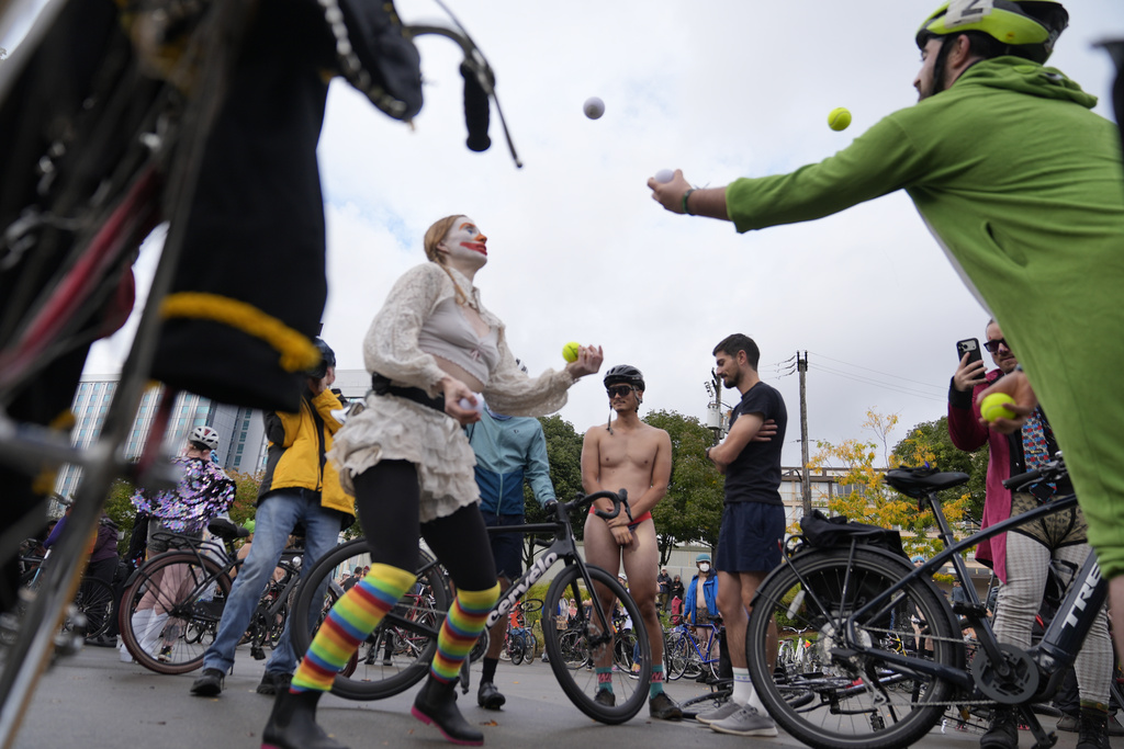 Participants prepare for the Naked Bike Ride protest on Sunday, Oct. 12, 2025, in Portland, Ore. (AP Photo/Jenny Kane)