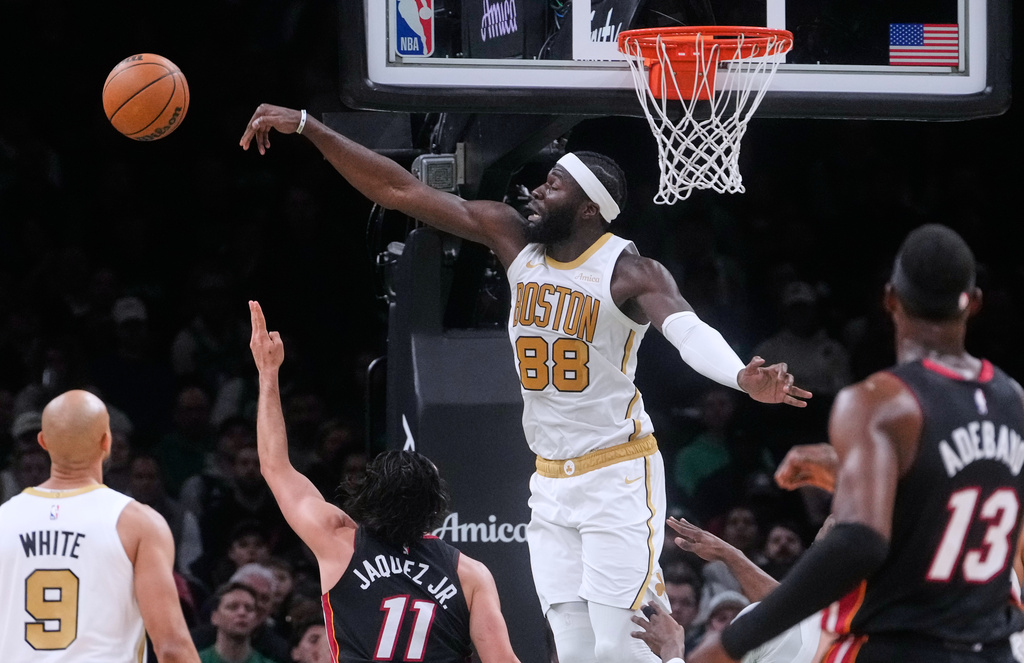 Boston Celtics center Neemias Queta (88) blocks a shot by Miami Heat forward Jaime Jaquez Jr. (11) during the first half of an NBA basketball game, Friday, Dec. 19, 2025, in Boston. (AP Photo/Charles Krupa)