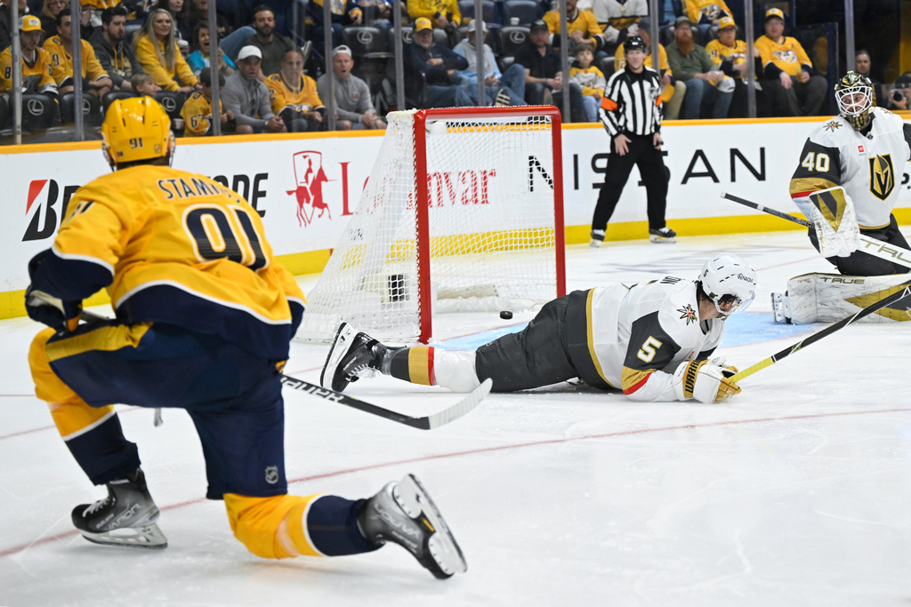 Vegas Golden Knights defenseman Jeremy Lauzon (5) lays on the ice as Nashville Predators center Steven Stamkos, left, makes a goal during the second period of an NHL hockey game Saturday, March 21, 2026, in Nashville, Tenn. (AP Photo/John Amis)