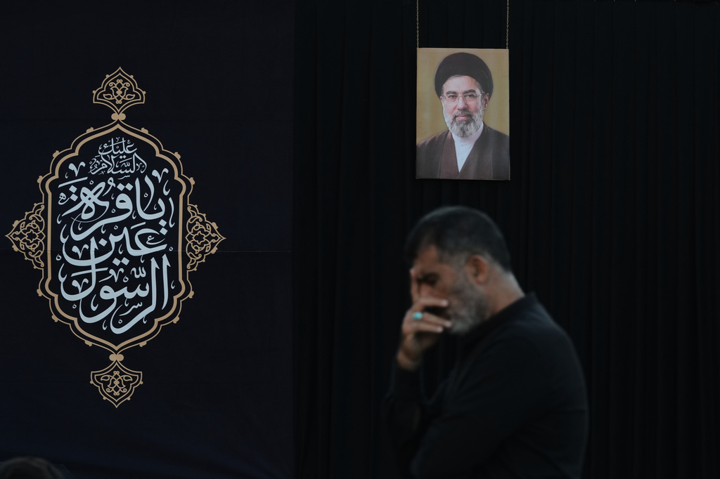 A man attends a sermon backdropped by a portrait of Iran's Supreme Leader Mojtaba Khamenei during a sermon marking the third day of Ashoura, the Shiite Muslim commemoration of the 7th-century death of Imam Hussein, the grandson of the Prophet Muhammad, in the southern port city of Tyre, Lebanon, Friday, June 19, 2026. (AP Photo/Hassan Ammar)