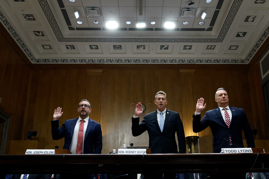 From left, Joseph Edlow, director of U.S. Citizenship and Immigration Services, Rodney Scott, commissioner of the U.S. Customs and Border Protection and Todd Lyons, senior official performing the duties of the director at U.S. Immigration and Customs Enforcement, are sworn in before a Senate Homeland Committee hearing on Capitol Hill in Washington, Thursday, Feb. 12, 2026, in Washington. (Chip Somodevilla/Pool via AP)