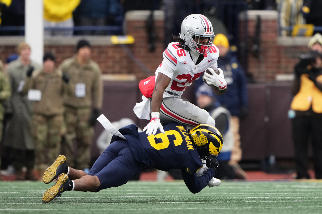 Ohio State running back Bo Jackson, top, is tackled by Michigan defensive back Brandyn Hillman during the first half of an NCAA college football game, Saturday, Nov. 29, 2025, in Ann Arbor, Mich. (AP Photo/Ryan Sun)