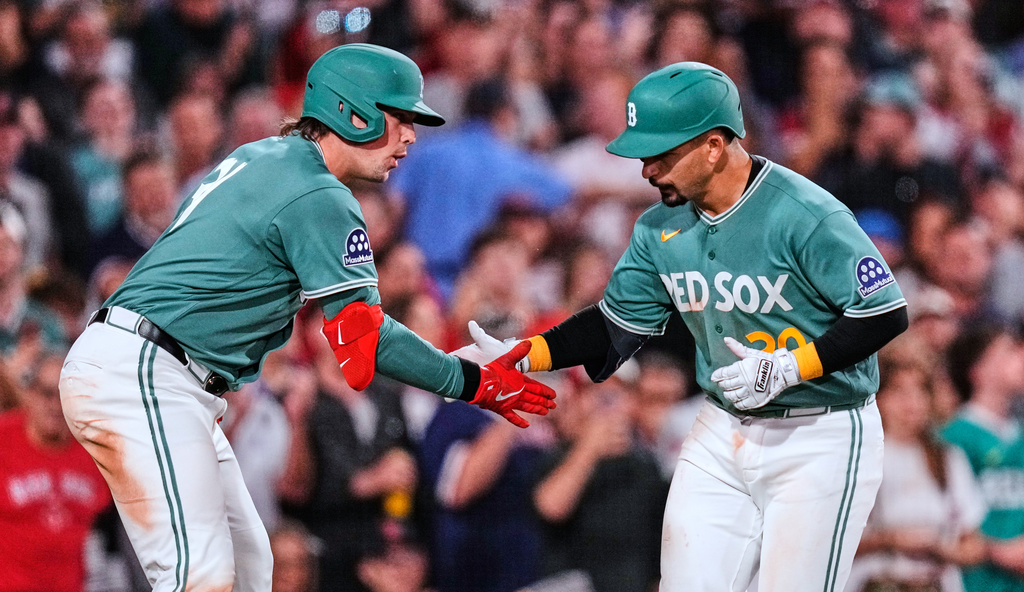 Boston Red Sox's Mickey Gasper, right, is congratulated by Adley Rutschman after his solo home run in the fifth inning of a baseball game against the Kansas City Royal, Friday, Sept. 11, 2026, in Boston. (AP Photo/Charles Krupa)