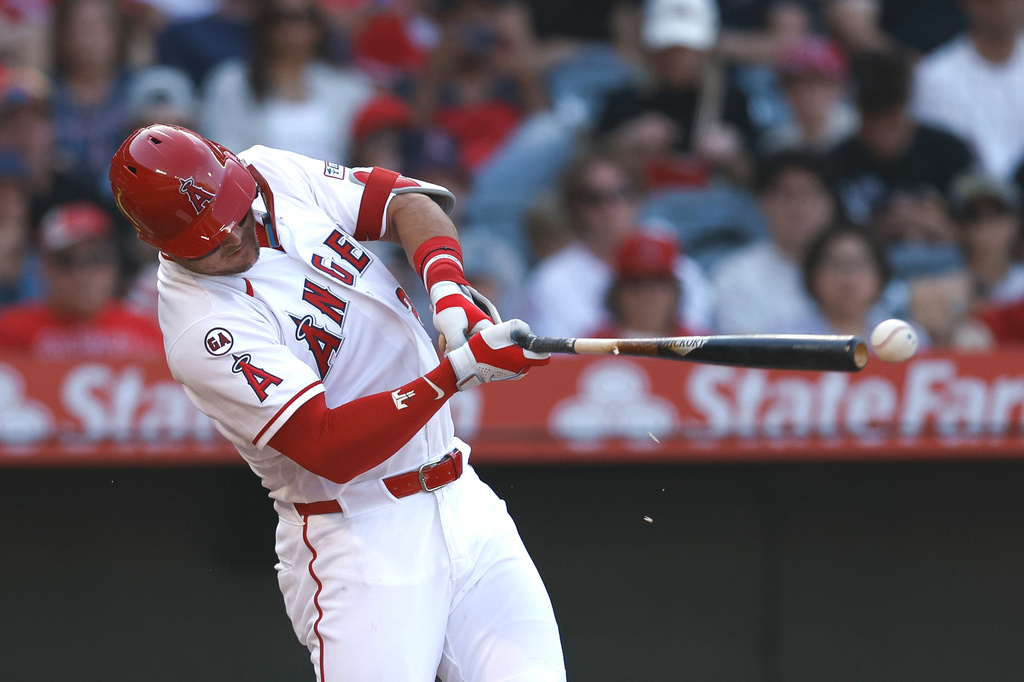 Los Angeles Angels' Mike Trou hits an RBI single that scored Angels' Sebastian Rivero during the third inning of a baseball game against the Texas Rangers, Sunday, May 24, 2026, in Anaheim, Calif. (AP Photo/Caroline Brehman)