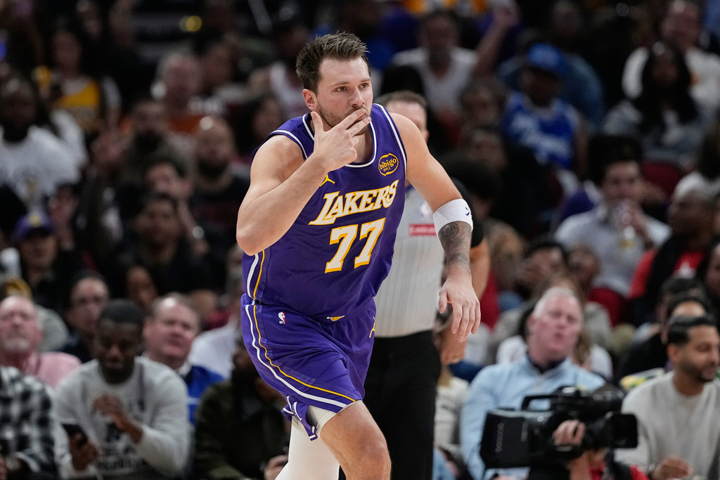 Los Angeles Lakers' Luka Doncic celebrates after making a 3-pointer against the Houston Rockets during the first half of an NBA basketball game Wednesday, March 18, 2026, in Houston. (AP Photo/David J. Phillip)