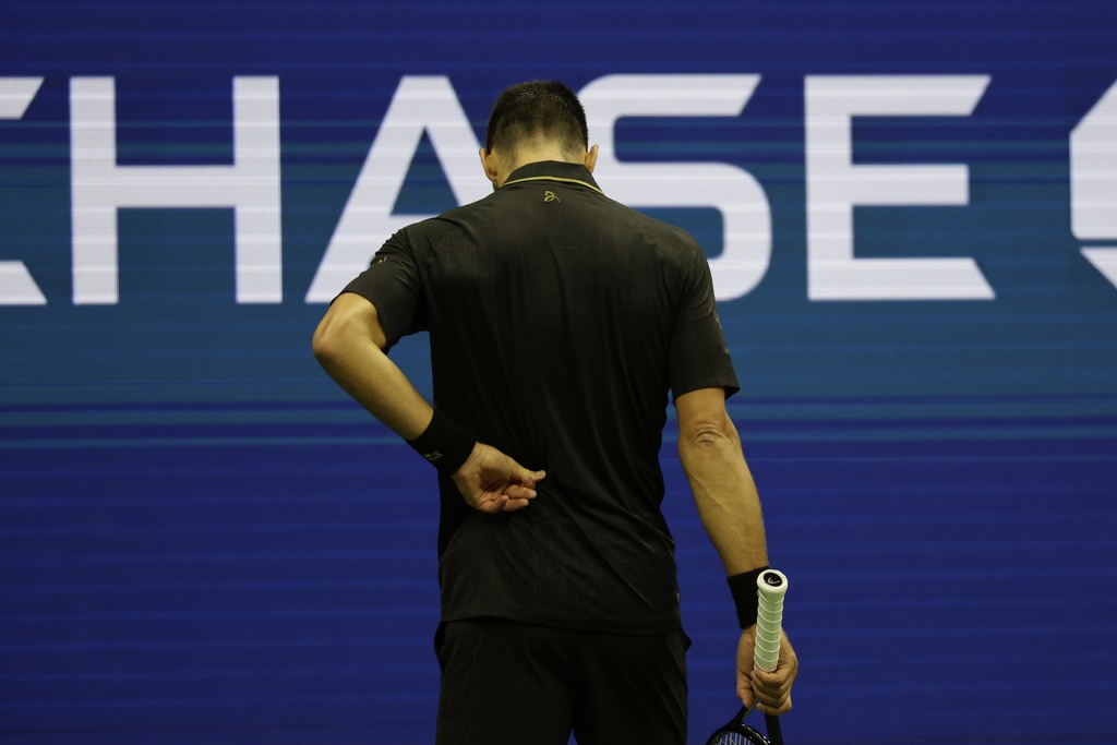 Novak Djokovic, of Serbia, holds his back against Cameron Norrie, of Great Britain, during the third round of the U.S . Open tennis championships, Friday, Aug. 29, 2025, in New York. (AP Photo/Adam Hunger)