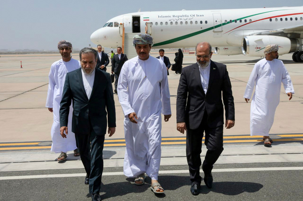 FILE - In this photo released by the Iranian Foreign Ministry, Iranian Foreign Minister Abbas Araghchi, left, is welcomed by an unidentified Omani official, center, upon his arrival at Muscat, Oman, for negotiations with U.S. Mideast envoy Steve Witkoff, as Iranian Ambassador to Oman Mousa Farhang walks at right, May 11, 2025. (Iranian Foreign Ministry via AP, File)