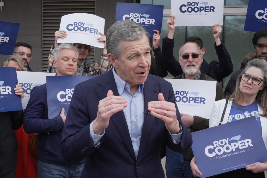 Democratic former Gov. Roy Cooper, who is running for U.S. Senate, speaks to reporters after casting his ballot on the first day of in-person early voting in the state's primary election, Thursday, Feb. 12, 2026, in Raleigh, N.C. (AP Photo/Allen G. Breed)