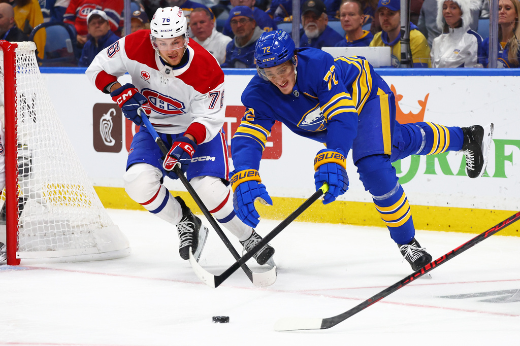 Montréal Canadiens right wing Zachary Bolduc (76) and Buffalo Sabres center Tage Thompson (72) battle for the puck during the first period in Game 2 of a second-round NHL hockey Stanley Cup playoff series Friday, May 8, 2026, in Buffalo, N.Y. (AP Photo/Jeffrey T. Barnes)