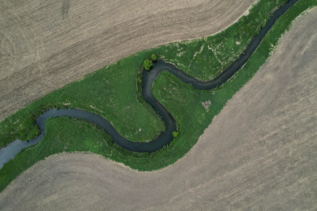 A stream cuts through a farm field Thursday, May 7, 2026, near Marshalltown, Iowa. (AP Photo/Brittany Peterson)