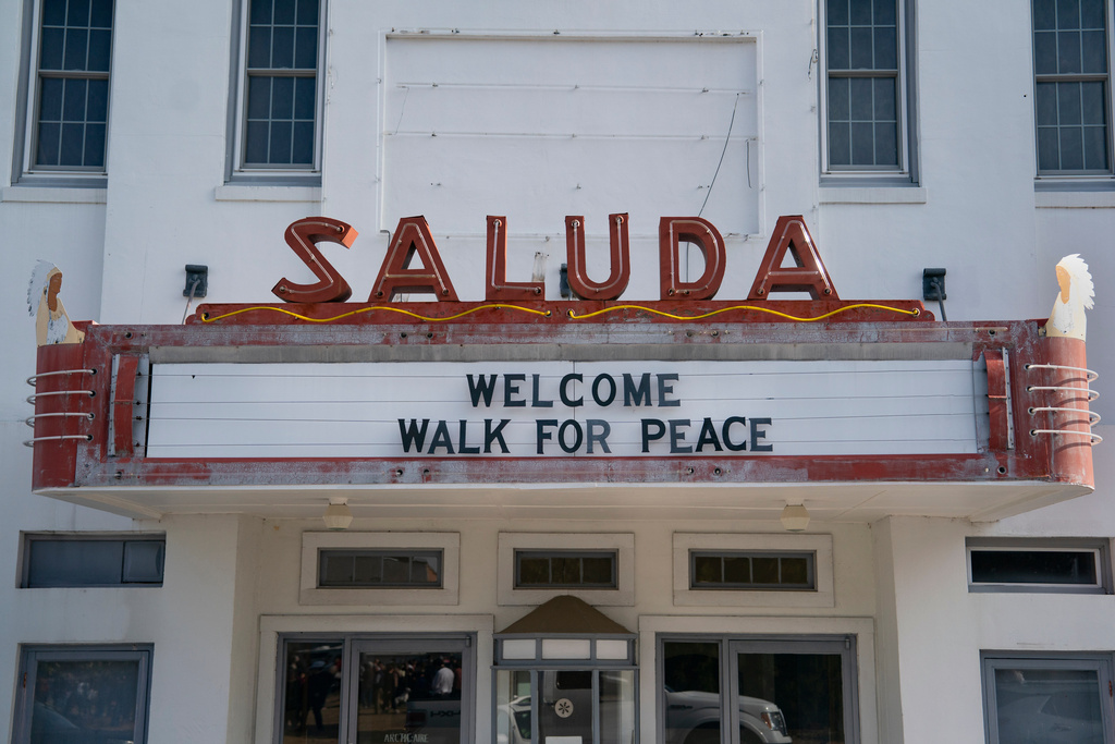 A sign is seen greeting the Buddhist monks who are participating in the, "Walk For Peace," Thursday, Jan. 8, 2026, in Saluda, S.C. (AP Photo/Allison Joyce)