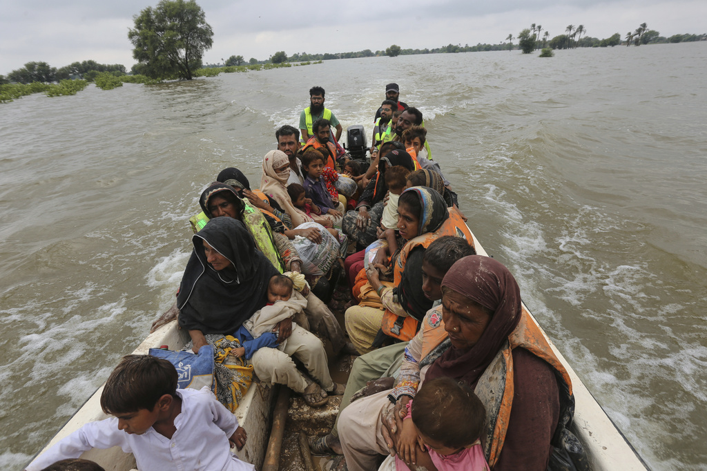 Rescue workers evacuate villagers from a flooded area following raising water level in rivers, in Jalalpur Pirwala, in Multan district, Pakistan, Monday, Sept. 8, 2025. (AP Photo/Asim Tanveer)