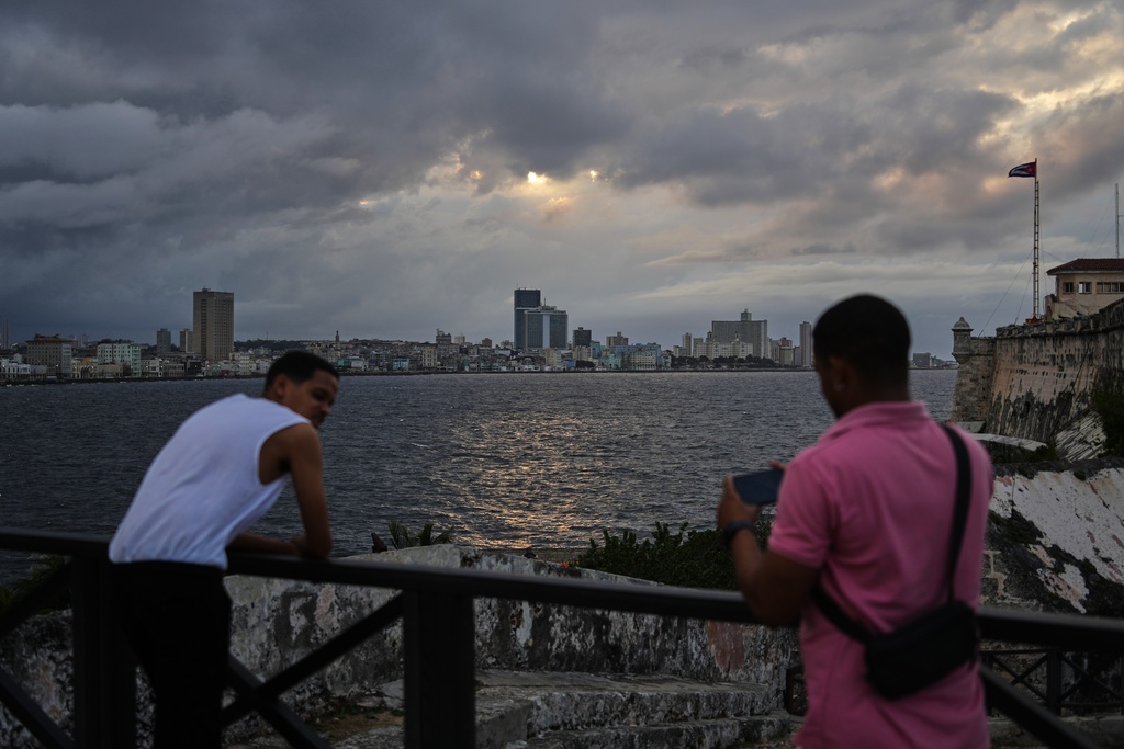 People take photos at El Morro in Havana, Monday, Jan. 26, 2026. (AP Photo/Ramon Espinosa)