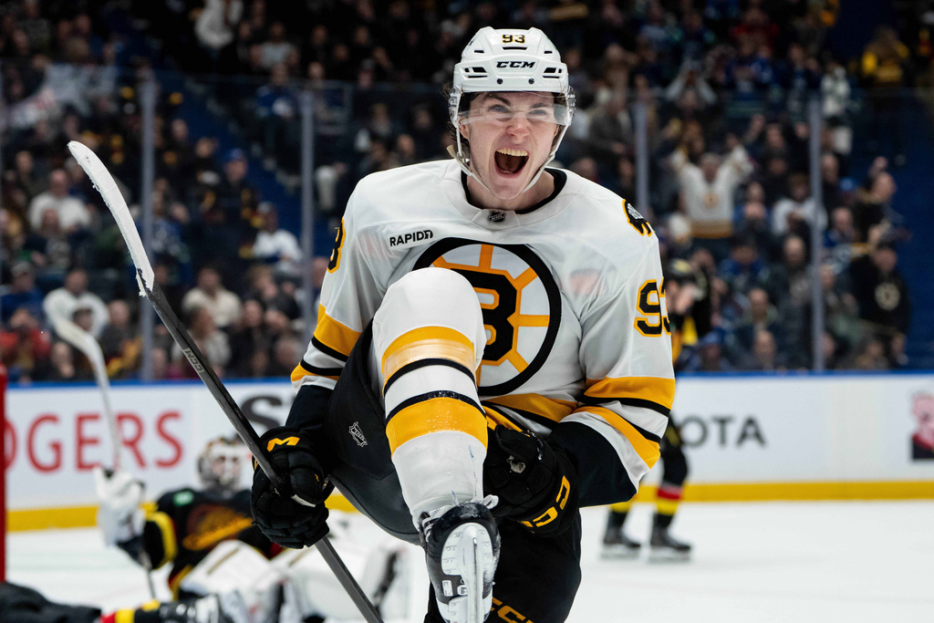 Boston Bruins' Fraser Minten (93) celebrates his game-winning goal against the Vancouver Canucks during overtime in an NHL hockey game in Vancouver, British Columbia, on Saturday, Jan. 3, 2026. (Ethan Cairns/The Canadian Press via AP)
