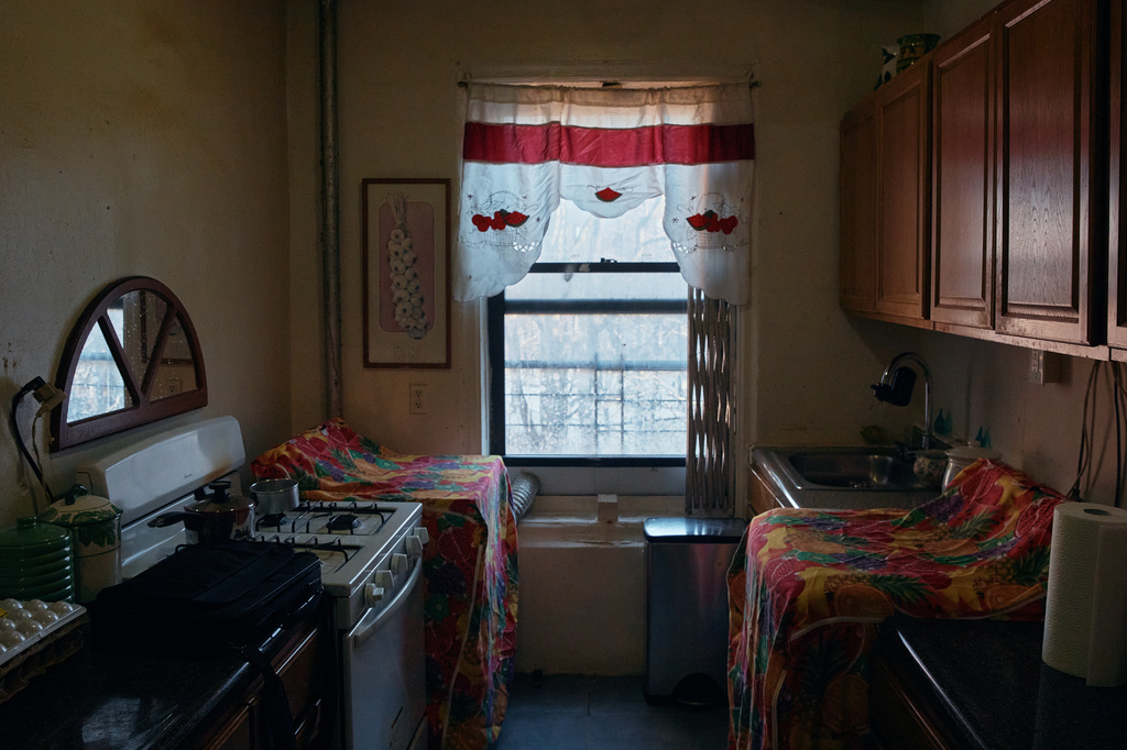 A curtain hangs over the window in Marina Quiroz's kitchen in an apartment building where tenants report maintenance issues and pest infestations, in the Bronx borough of New York, Tuesday, March 17, 2026. (AP Photo/Andres Kudacki)
