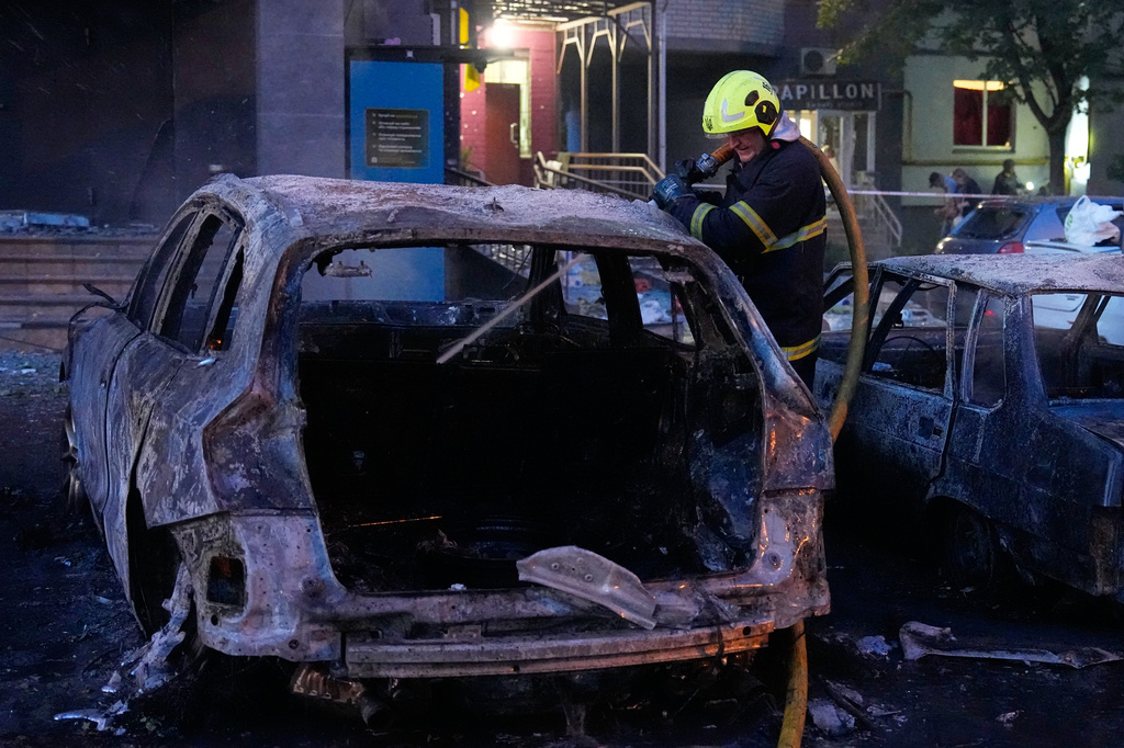 Emergency services personnel work to extinguish a fire following Russian missile attacks in Kyiv, Ukraine, Saturday, Aug. 1, 2026. (AP Photo/Efrem Lukatsky)