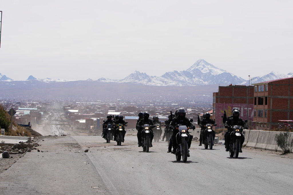 Police patrol a highway after President Rodrigo Paz declared a state of emergency to empower the military to remove road blockades, in El Alto, Bolivia, Saturday, June 20, 2026. (AP Photo/Juan Karita)