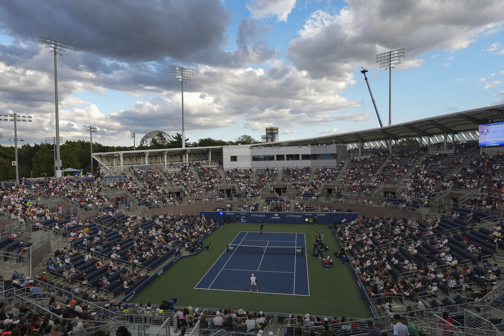 Alex de Minaur, of Australia, top in black, serves to Christopher O'Connell, of Australia, during the first round of the U.S. Open tennis championships, Tuesday, Aug. 26, 2025, in New York. (AP Photo/Frank Franklin II)
