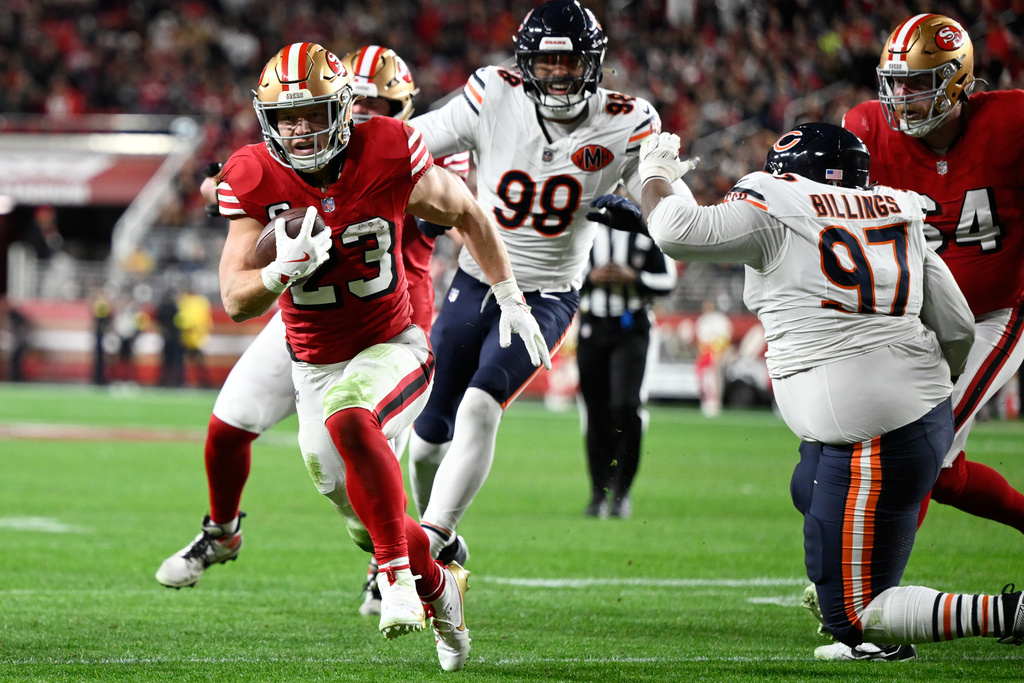 San Francisco 49ers running back Christian McCaffrey (23) runs toward the end zone to score against the Chicago Bears during the first half of an NFL football game in Santa Clara, Calif., Sunday, Dec. 28, 2025. (AP Photo/Eakin Howard)