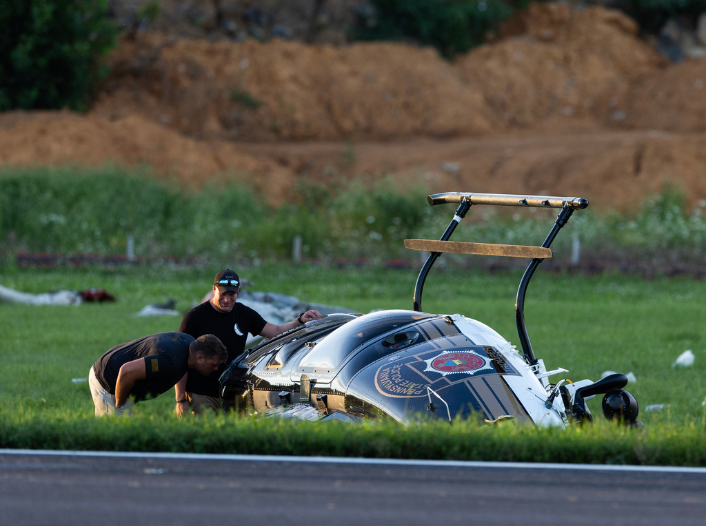Authorities investigate a crash between a Pennsylvania State Police helicopter and a small plane at the Carlisle airport in Carlisle, Pa. Wednesday, Aug. 19, 2026. (Sean Simmers/The Patriot-News via AP)