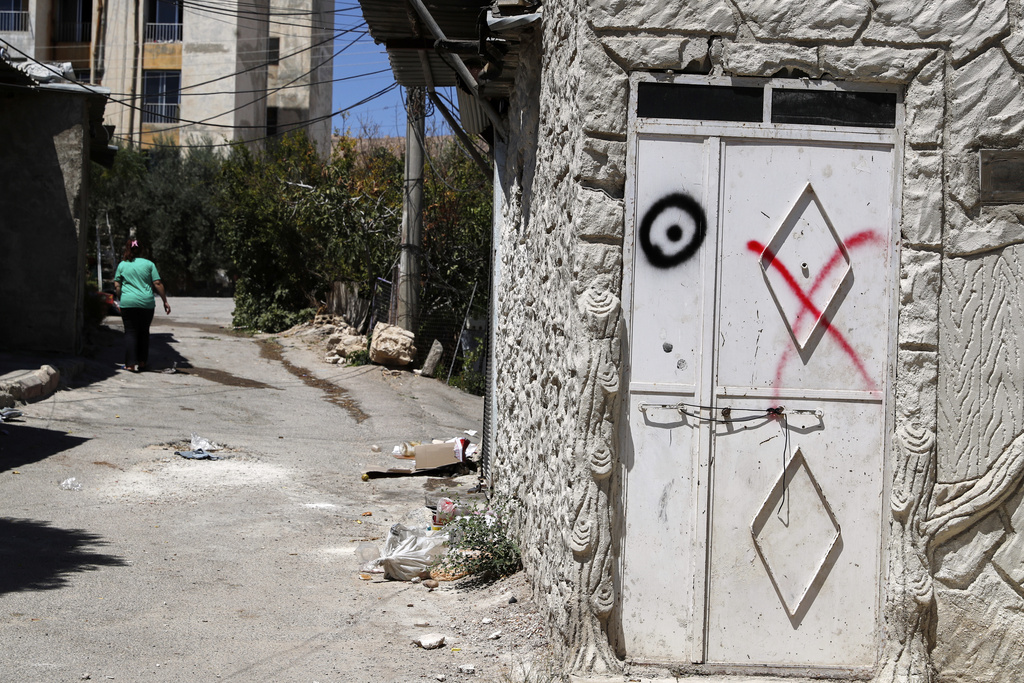 A house door is seen marked with "XO", indicating an order for the family living there to leave, in Sumariya, a suburb northwest of Damascus, Syria, Saturday, Aug. 30, 2025. (AP Photo/Omar Sanadiki)