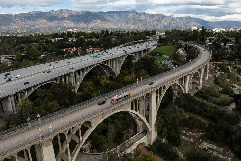 Motorists cross the historic Colorado Street Bridge in the foreground, a Route 66 landmark in Pasadena, Calif., Saturday, Nov. 22, 2025. (AP Photo/Jae C. Hong)