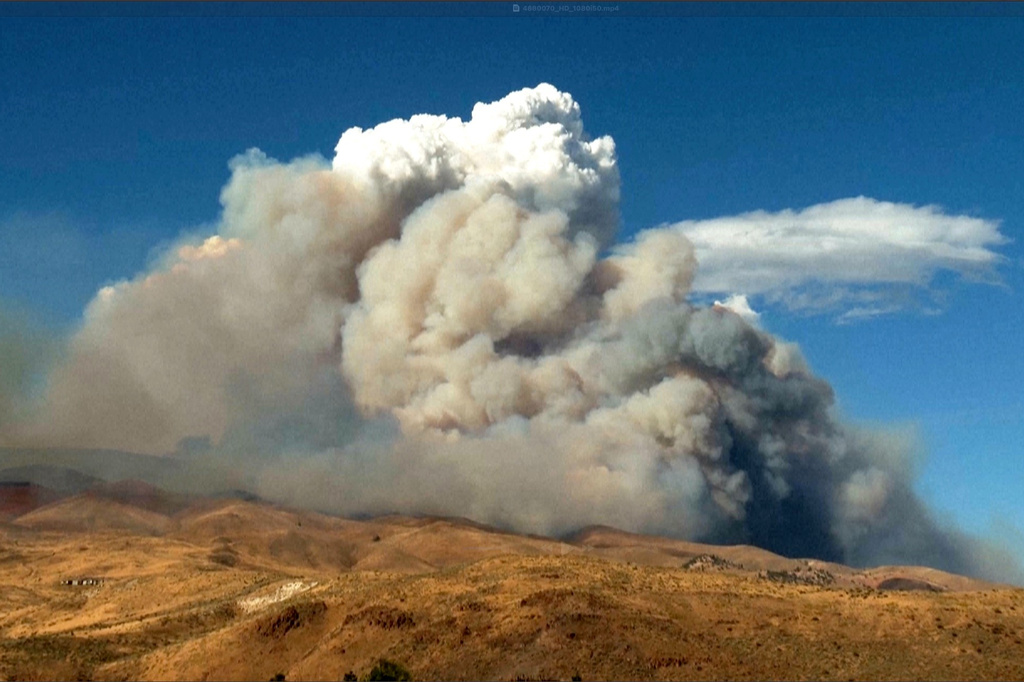 This image taken from video shows plumes of smoke rising from active wildfires Saturday, Aug. 22, 2026, in Reno, Nevada. (Tim Walton via AP)