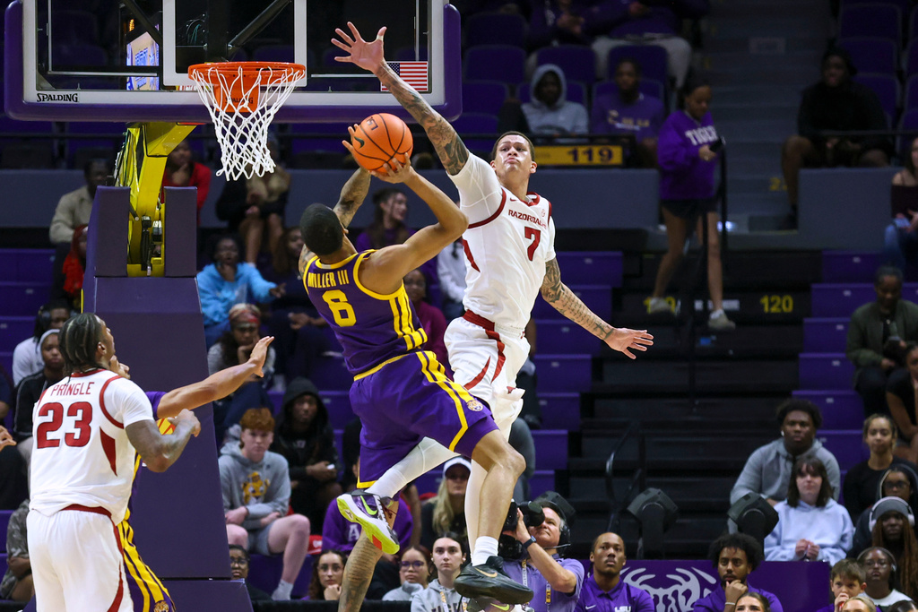 LSU forward Robert Miller III (6) attempts a shot against Arkansas forward Trevon Brazile (7) during the first half of an NCAA college basketball game in Baton Rouge, La., Tuesday, Feb. 10, 2026. (AP Photo/Peter Forest)