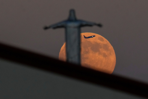 A Southwest Airlines plane appears between the Harvest Supermoon and a statue of Jesus Christ atop Iglesia Luterana Santa Maria de Guadalupe as it takes off from Dallas Love Field Airport, Monday, Oct. 6, 2025, in Irving, Texas. (AP Photo/Julio Cortez) A Southwest Airlines plane appears between the Harvest Supermoon and a statue of Jesus Christ atop Iglesia Luterana Santa Maria de Guadalupe as it takes off from Dallas Love Field Airport, Monday, Oct. 6, 2025, in Irving, Texas. (AP Photo/Julio Cortez)
