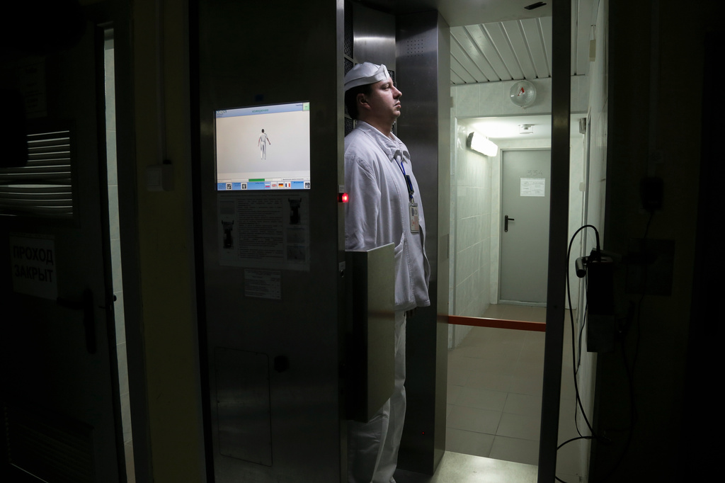FILE - A worker checks radiation levels after leaving a nuclear waste storage site at the Chernobyl nuclear power plant in Chernobyl, Ukraine, March 23, 2016. (AP Photo/Efrem Lukatsky, File)