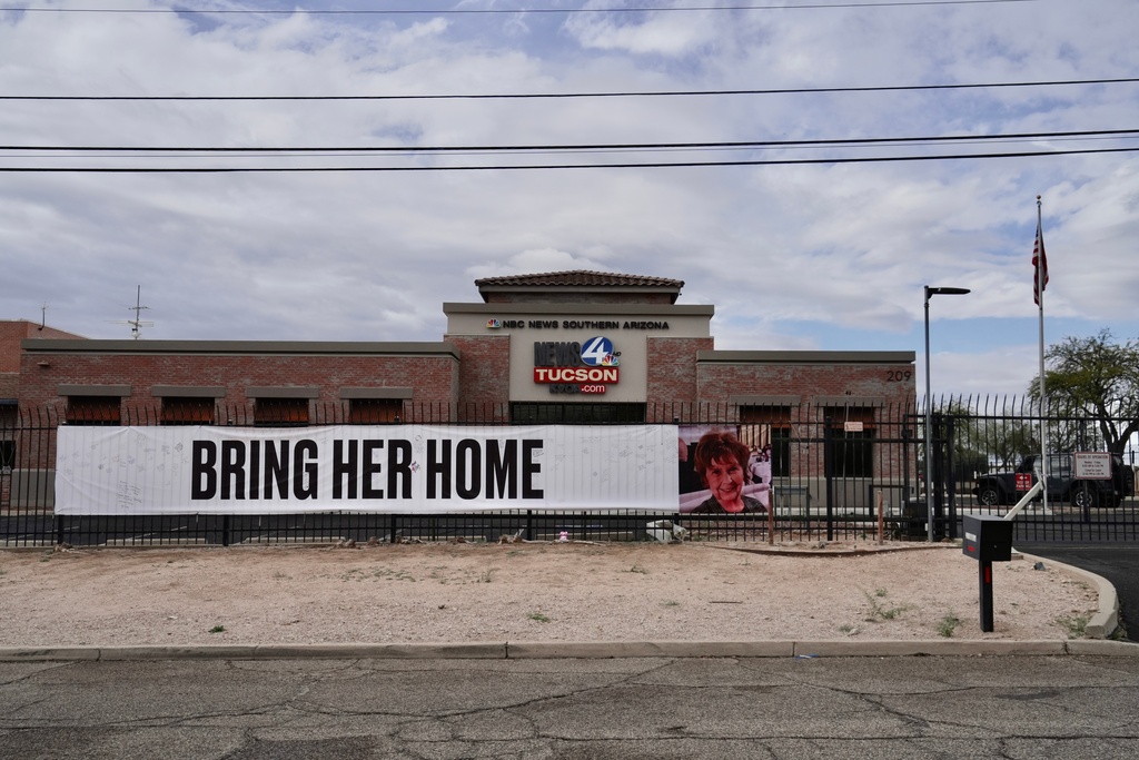 A banner reading "Bring her home" on a fence outside of the KVOA news station in Tucson, Ariz., on Friday, Feb. 13, 2026. (AP Photo/Ty ONeil)