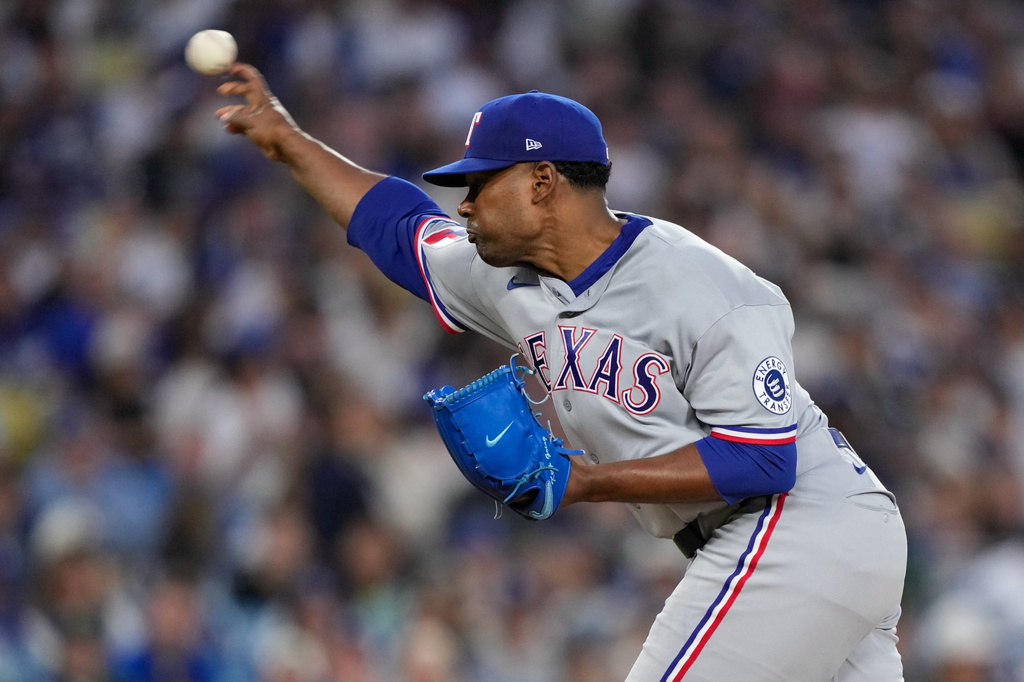 Texas Rangers pitcher Kumar Rocker throws to the plate during the first inning of a baseball game against the Los Angeles Dodgers, Friday, April 10, 2026, in Los Angeles. (AP Photo/Mark J. Terrill)