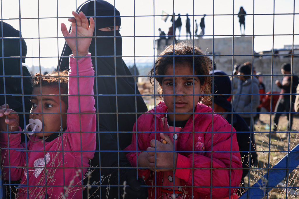 People stand inside the al-Hol camp in northeastern Syria's Hasakeh province, Syria, Wednesday, Jan. 21, 2026, after the withdrawal of the Syrian Democratic Forces (SDF). (AP Photo/Ghaith Alsayed)