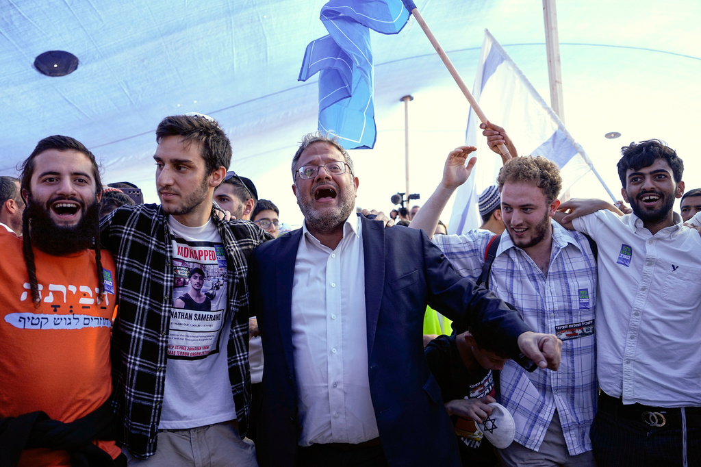 FILE - Israel's far-right National Security Minister Itamar Ben-Gvir, center, dances during a conference calling for Jewish resettlement of the Gaza Strip, near the Israeli-Gaza border in southern Israel, Oct. 21, 2024. (AP Photo/Tsafrir Abayov, File)