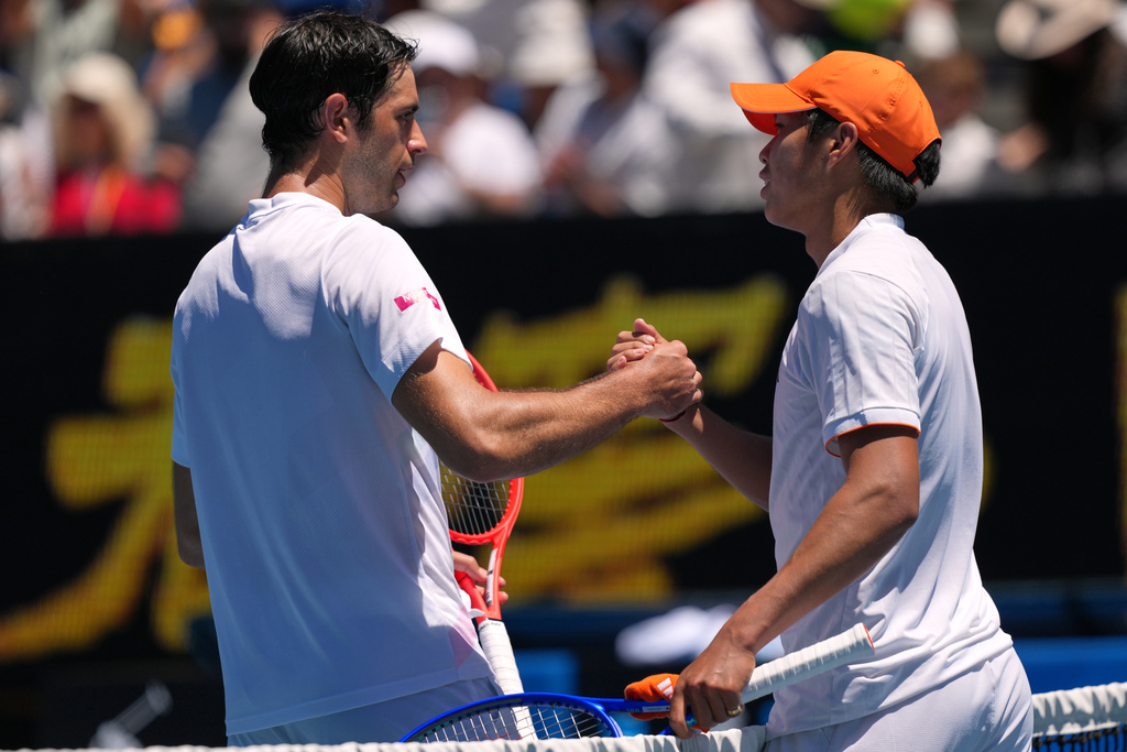 Learner Tien, right, of the U.S. is congratulated by Nuno Borges, left, of Portugal during their third round match at the Australian Open tennis championship in Melbourne, Australia, Friday, Jan. 23, 2026. (AP Photo/Dar Yasin)