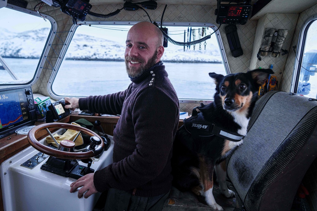 Helgi Aargil, fisherman, with his dog Molly, sails on his boat near Nuuk, Greenland, on Wednesday, Jan. 21, 2026. (AP Photo/Evgeniy Maloletka)