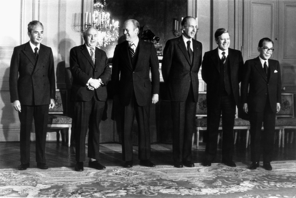 FILE - From left: Premier Aldo Moro of Italy, Premier Harold Wilson of the Great Britain, President Gerald Ford of the United States, President Valery Giscard d'Estaing of France, Chacellor Helmut Schmidt of West Germany and Premier Takeo Miki of Japan, the six heads of state and government, pose for a group portrait during the Economic and Monetary summit meeting at the Chateau de Rambouillet, West of Paris, Nov. 17, 1975. (AP Photo, File)
