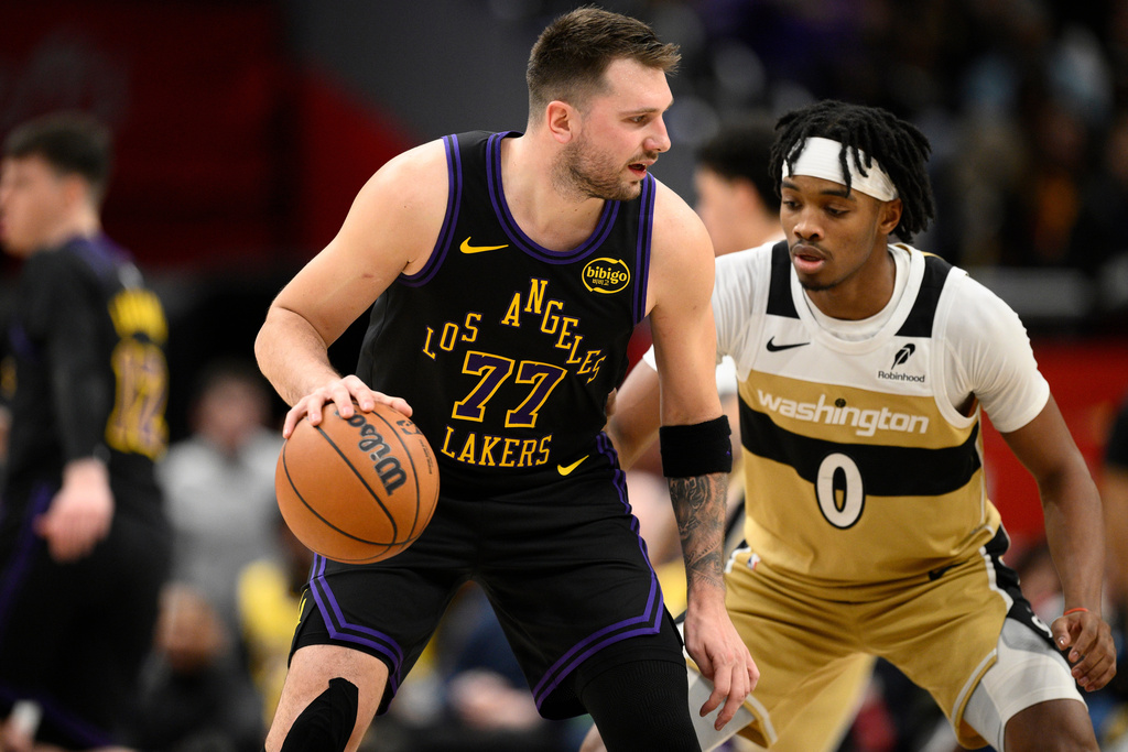 Los Angeles Lakers guard Luka Doncic (77) dribbles against Washington Wizards guard Bilal Coulibaly (0) during the first half of an NBA basketball game, Friday, Jan. 30, 2026, in Washington. (AP Photo/Nick Wass)
