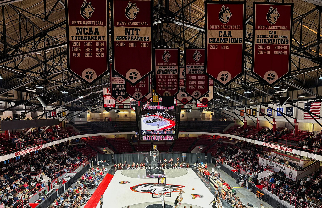 College championship flags hang over the court at Northeastern University's Matthews Arena, Nov. 24, 2025, in Boston. (AP Photo/Jimmy Golen)