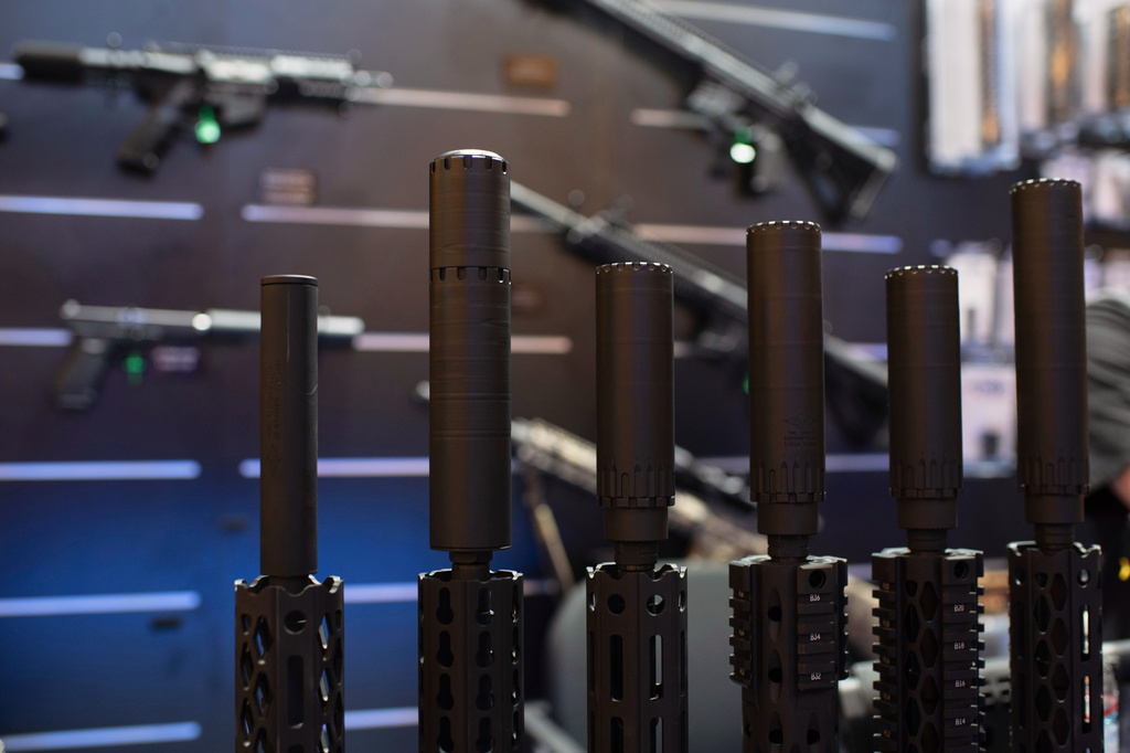 FILE - Firearms and suppressors are displayed at SHOT Show, the annual trade show for the gun industry, Jan. 21 2020, in Las Vegas. (AP Photo/Lisa Marie Pane, File)