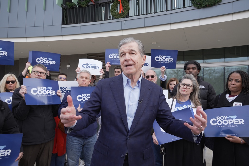 Democratic former Gov. Roy Cooper, who is running for U.S. Senate, speaks to reporters after casting his ballot on the first day of in-person early voting in the state's primary election, Thursday, Feb. 12, 2026, in Raleigh, N.C. (AP Photo/Allen G. Breed)