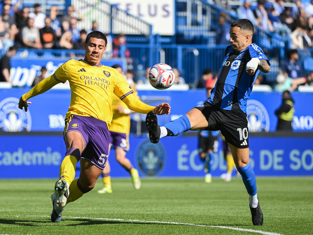 CF Montreal's Ivan Jaime (10) challenges Orlando City's Iago Teodoro for the ball during the first half of an MLS soccer game in Montreal, Saturday, May 9, 2026. (Graham Hughes/The Canadian Press via AP)