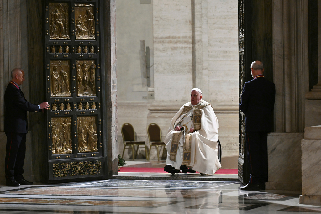 FILE - Pope Francis opens the Holy Door of St Peter's Basilica to mark the start of the Catholic Jubilee Year, at the Vatican, Dec. 24, 2024. (Alberto Pizzoli/Pool Photo via AP, file)