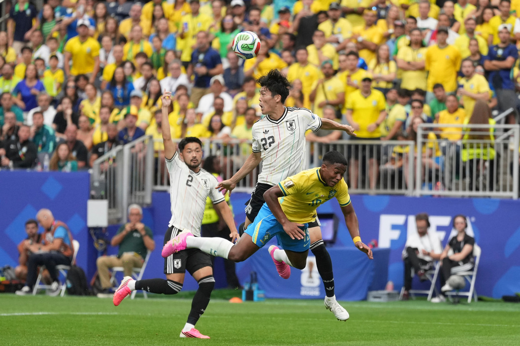 Japan's Takehiro Tomiyasu (22) battles for the ball with Brazil's Endrick (19) during the World Cup round of 32 soccer match between Brazil and Japan in Houston, on Monday, June 29, 2026. (AP Photo/Eric Gay)
