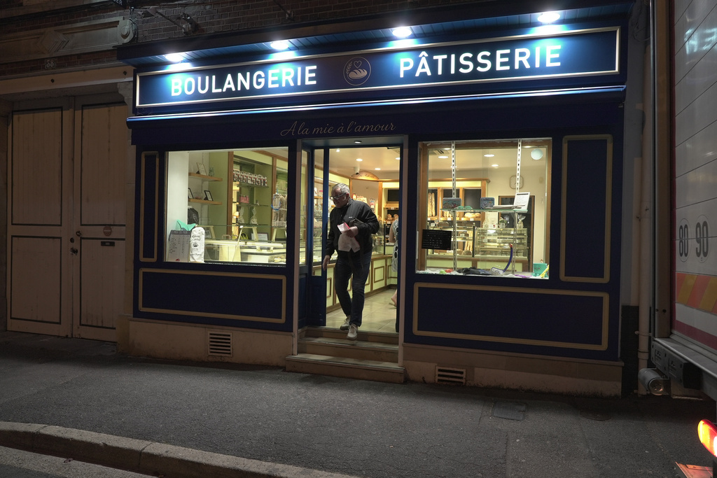 A customer leaves the bakery of Kevin Luce in Saint-Just-en-Chaussee, France, Thursday Sept. 24, 2026. (AP Photo/John Leicester)