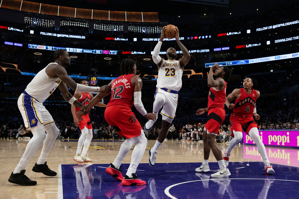 Los Angeles Lakers forward LeBron James (23) goes up for a basket during the first half of an NBA basketball game against the Toronto Raptors in Los Angeles, Sunday, Jan. 18, 2026. (AP Photo/Kyusung Gong)
