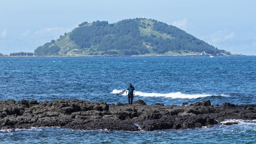 A police officer searches for missing woman, Jang Mi-ran, on Jeju Island, South Korea, Monday, Aug. 24, 2026. (Park Ji-ho/Yonhap via AP)