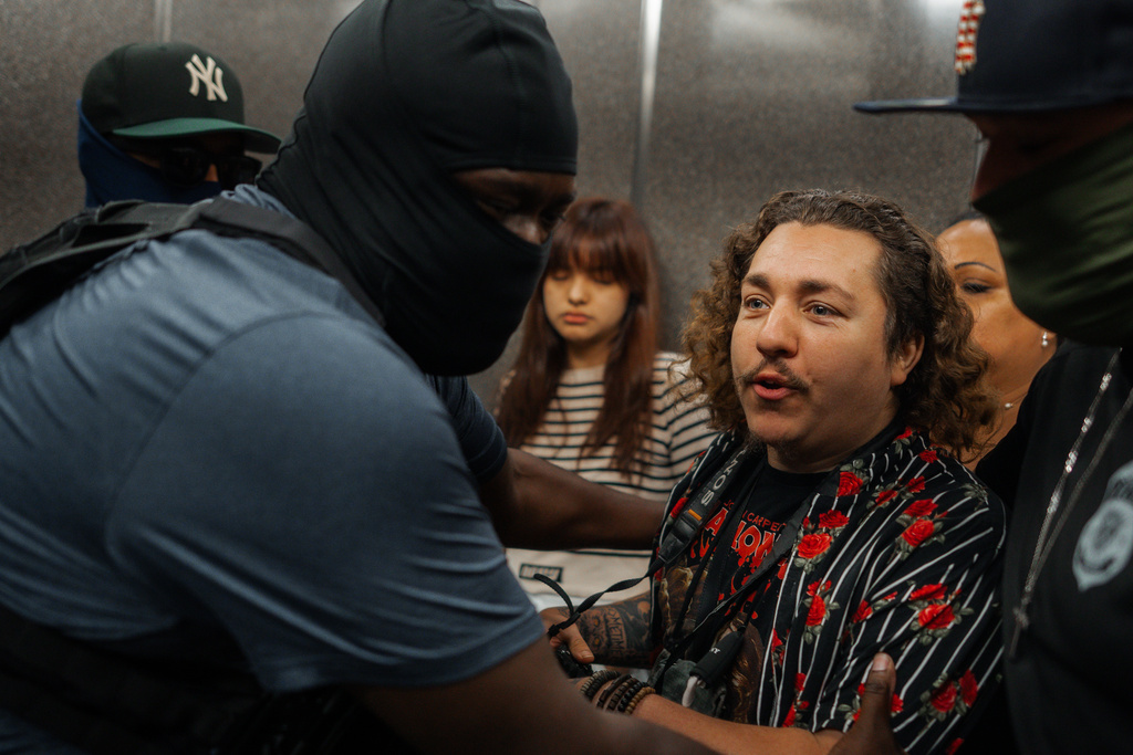Federal agents push photojournalist Dean Moses while making a detention in immigration court on Tuesday, Sept. 30, 2025, in New York. (AP Photo/Olga Fedorova)